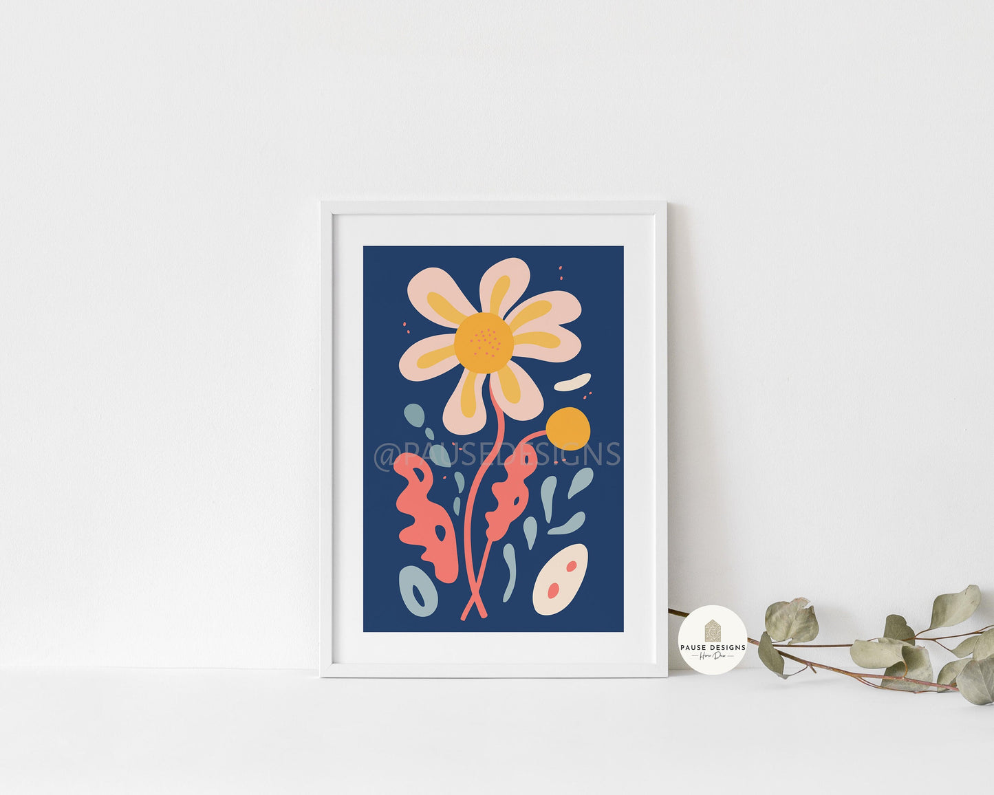 a picture of a flower on a wall next to a plant