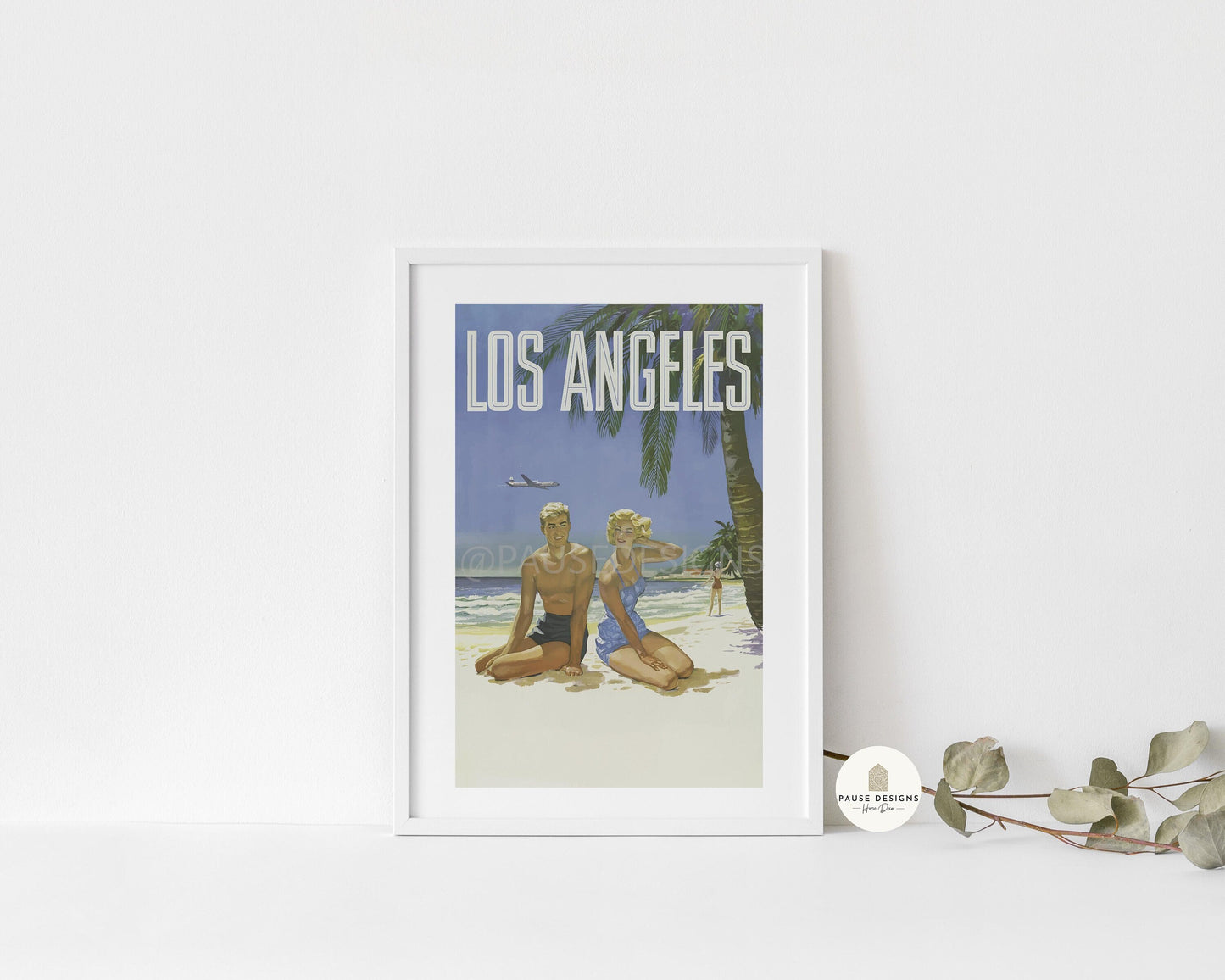 a picture of a couple sitting on the beach