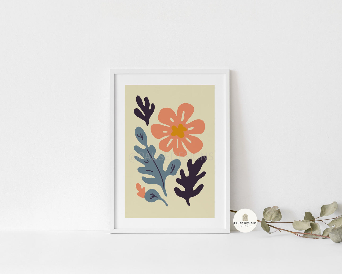 a picture of a flower on a wall next to a plant