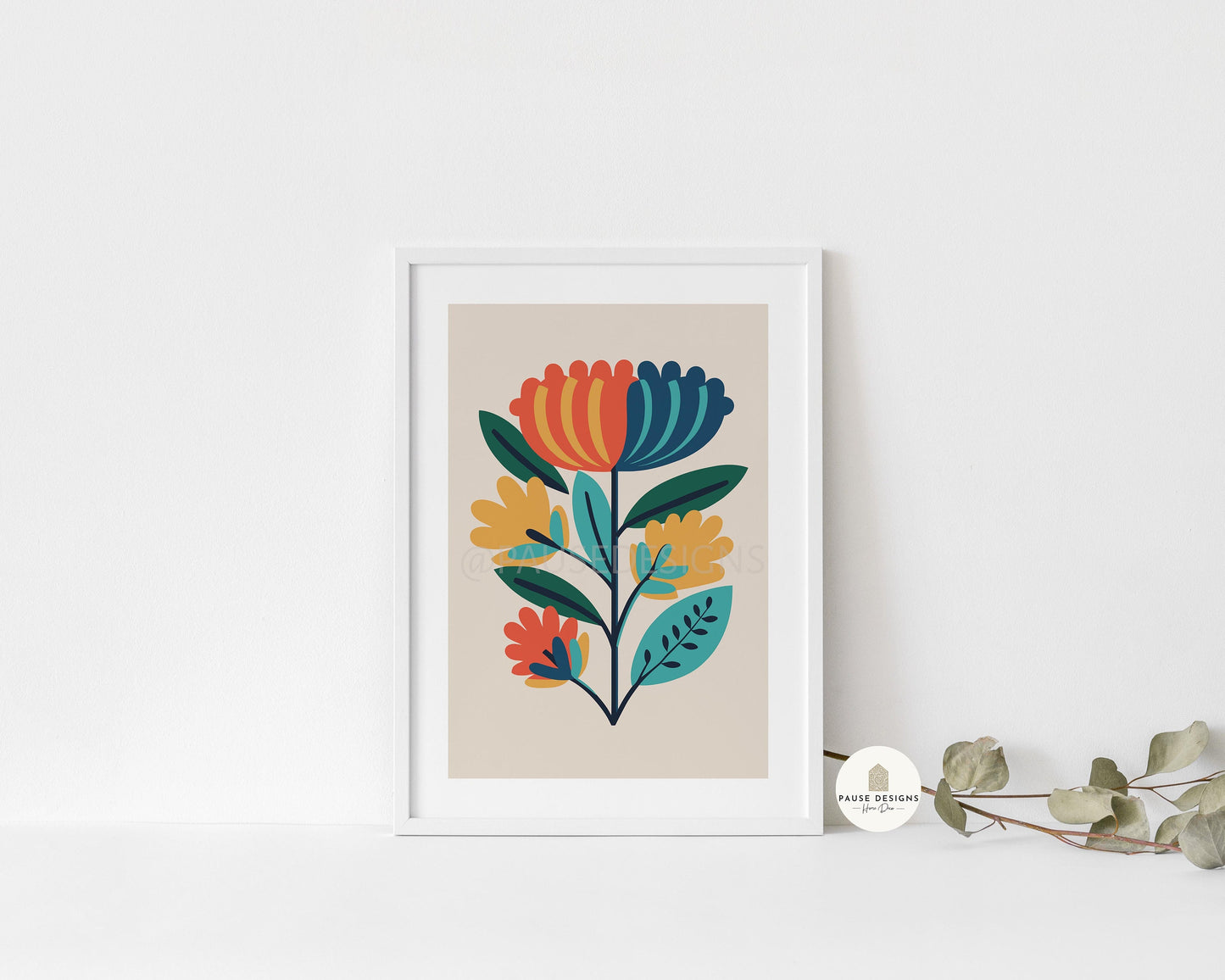 a picture of a flower on a wall next to a plant