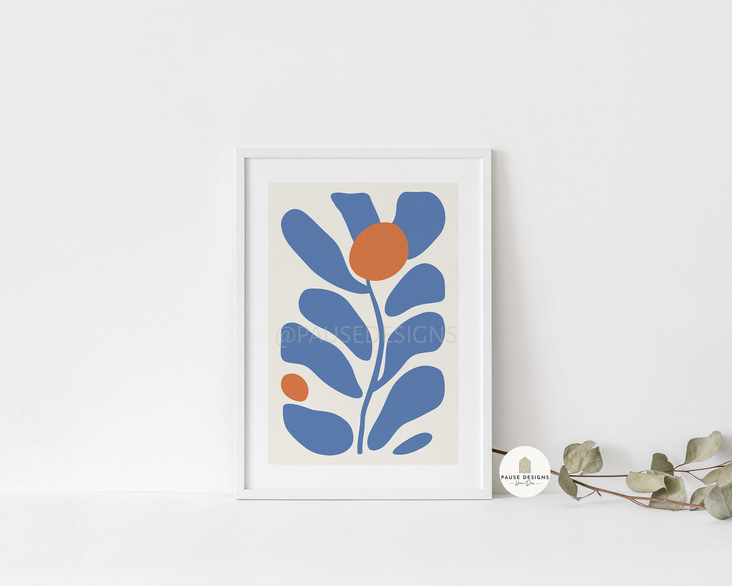 a picture of a blue and orange flower on a white wall