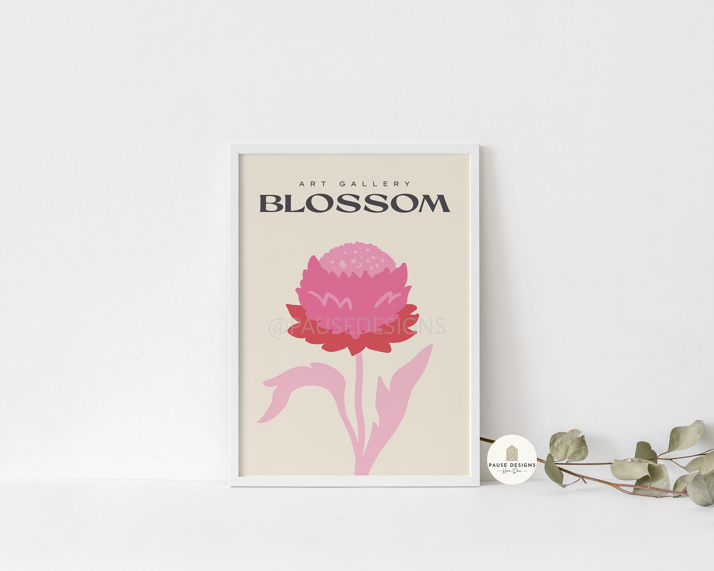 a picture of a pink flower on a shelf