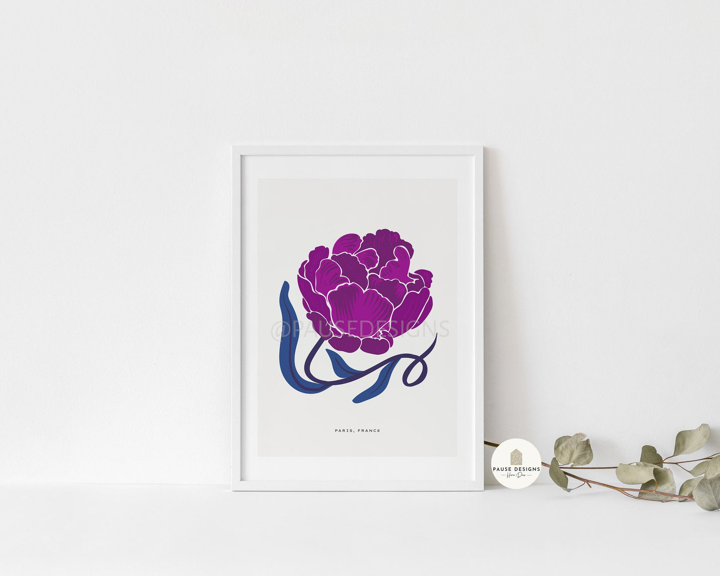 a picture of a purple flower on a white wall