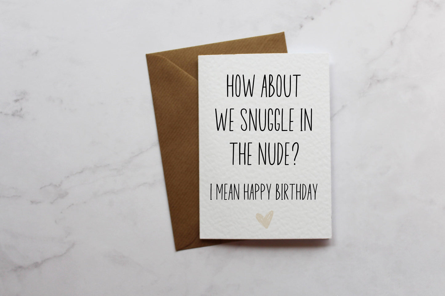 a card that says how about we snuggle in the nude? i mean