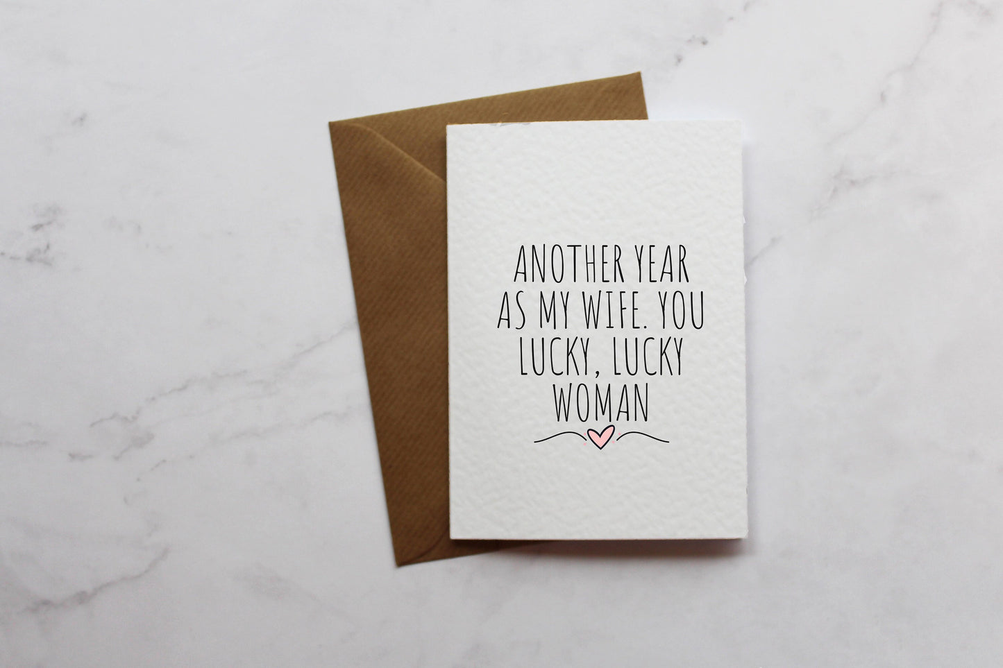 a card that says, another year as my wife you lucky lucky woman