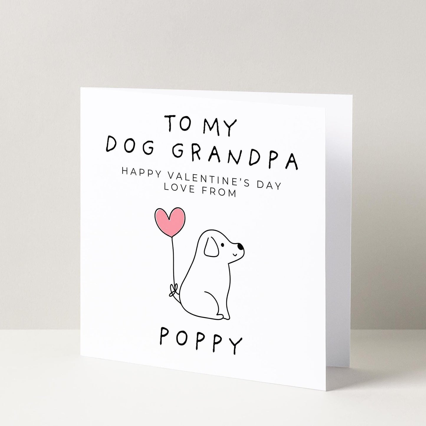 a card with a dog holding a heart balloon