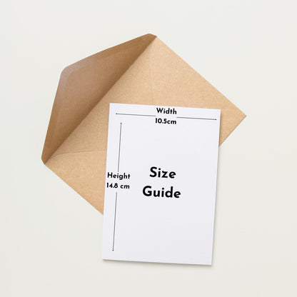 a white card with a brown envelope placed on a white background. The card has a guide size written on it, indicating the dimensions of the card and the envelope.