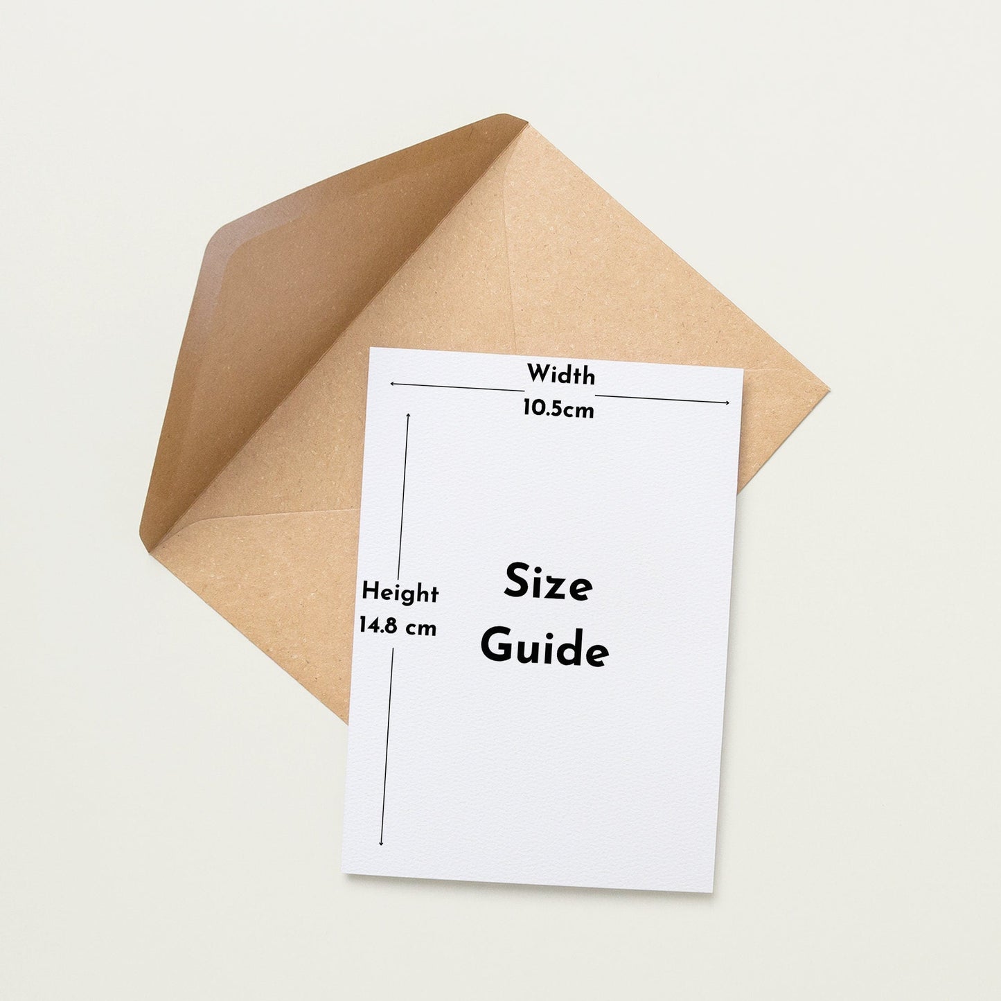 a white paper with measurements and text, placed next to an envelope.