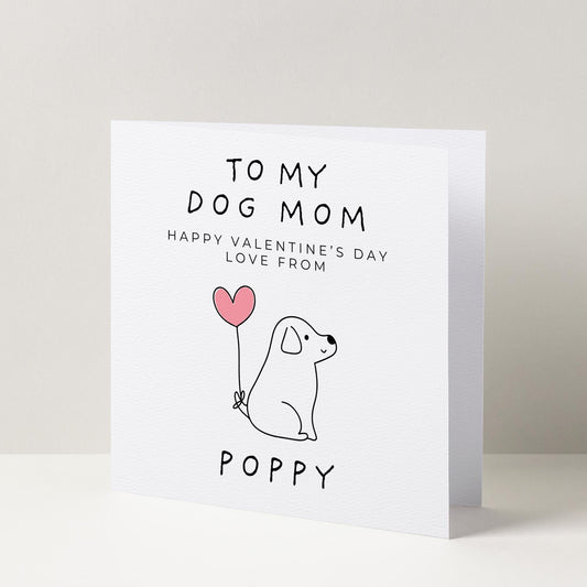 a card with a dog holding a heart balloon