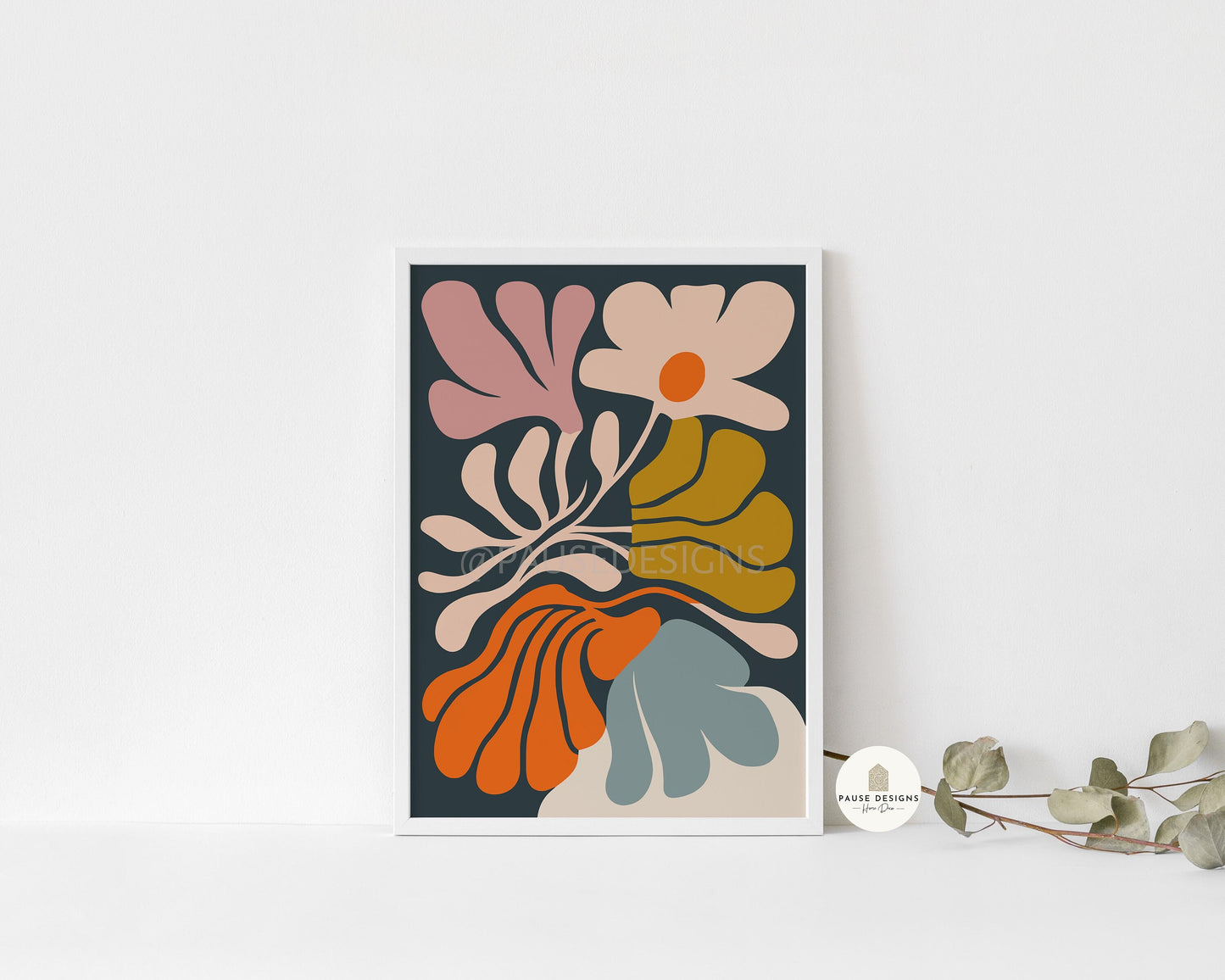 a picture of a flower on a shelf next to a plant