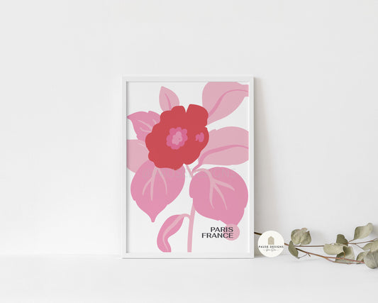 a picture of a pink flower on a white wall