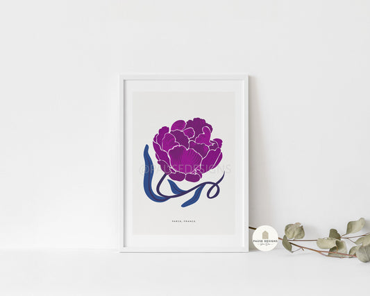 a picture of a purple flower on a white wall