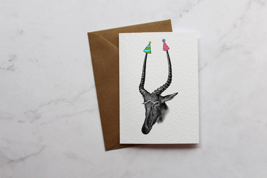 a card with a picture of an antelope and a bird on it