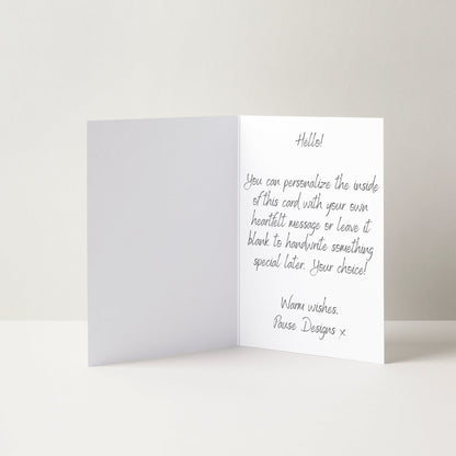 a white greeting card with a handwritten message