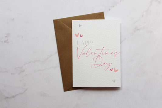 a valentine&#39;s day card on a marble surface